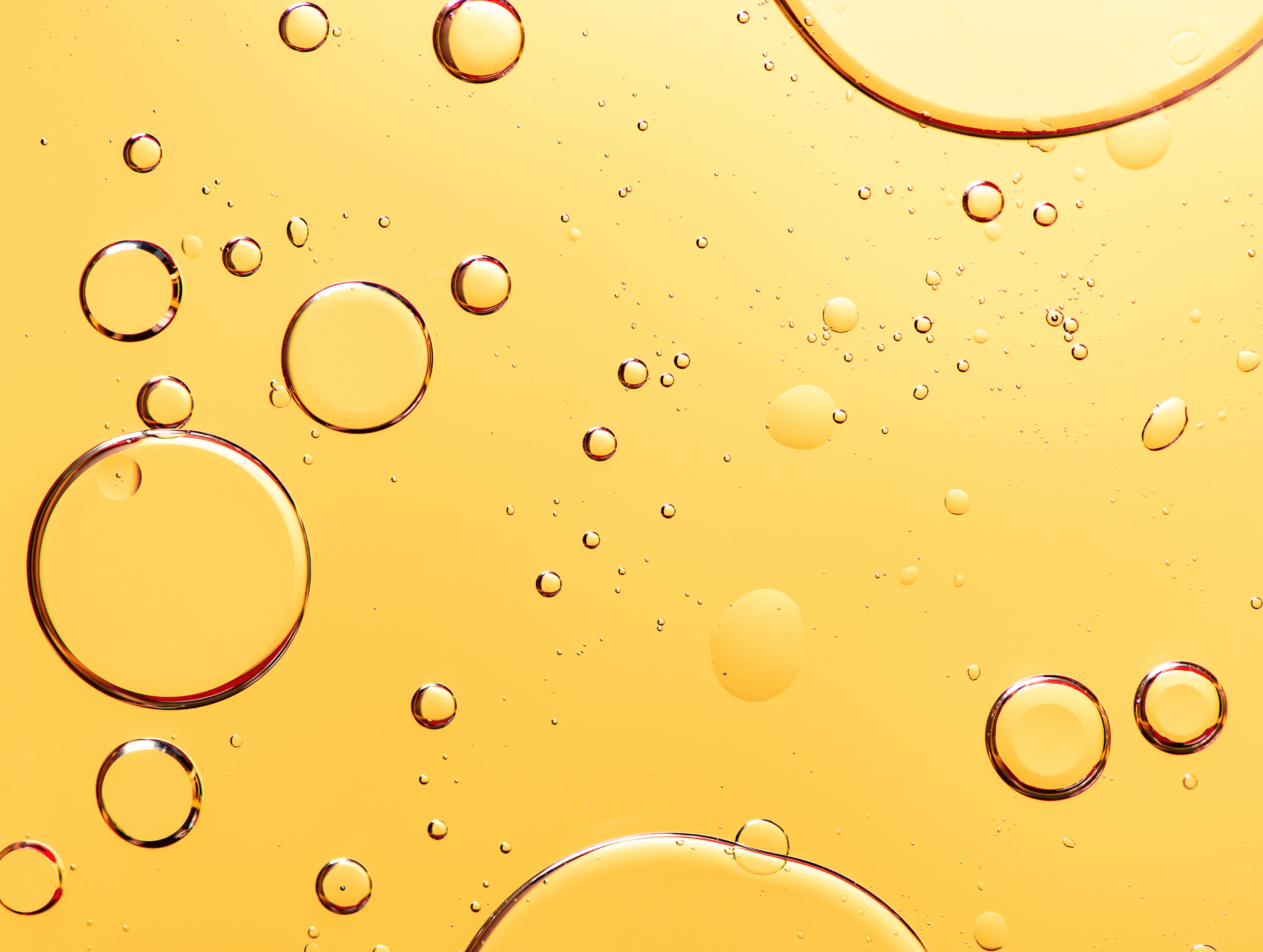 An ambiguous image of bubbles on a yellow surface. 