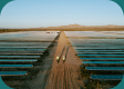 Two workers walking on a solar panel facility