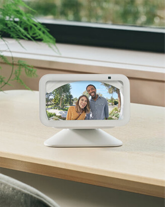 Two people appear smiling on the screen of an Amazon Echo Show device.