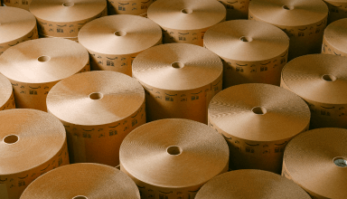 Neatly wound rolls of paper material. 