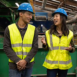 Two people in yellow vests and hard hats