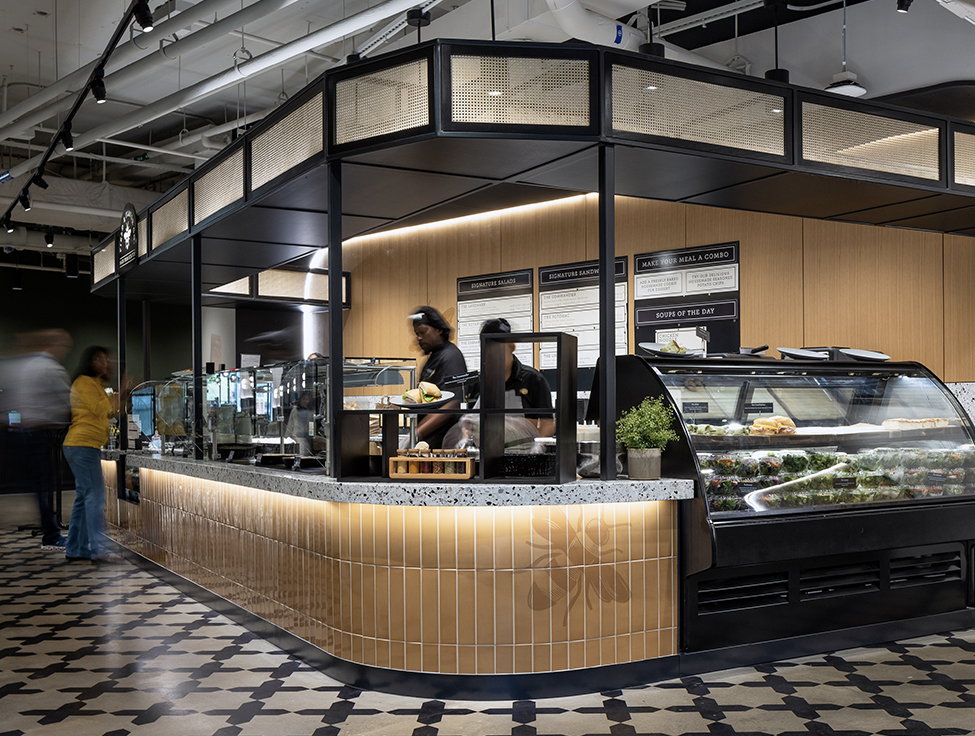 A cafe setting with two people working behind a counter.