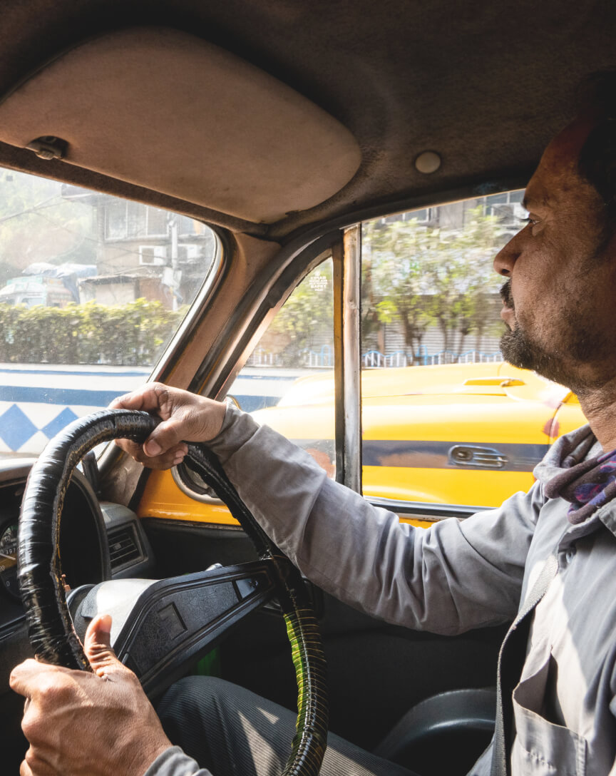 A person is shown driving from the inside of a vehicle.