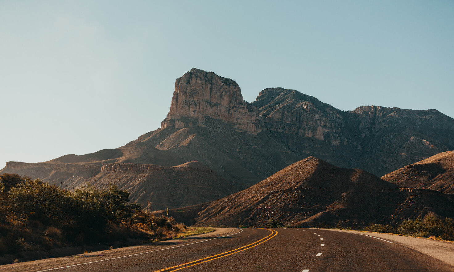 A desert landscape is shown in the distance in front of an open road alongside text about "partnering to decarbonize transportation." 