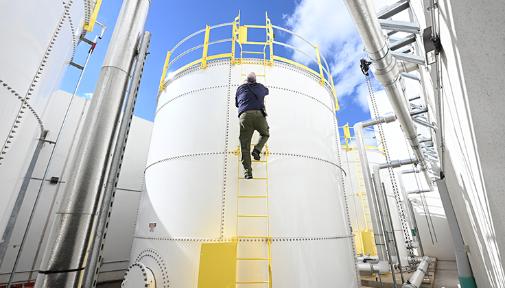 A person climbing up a tower.