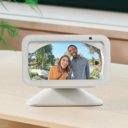 Two people appear smiling on the screen of an Amazon Echo Show device.