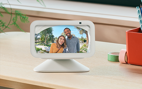 Two people appear smiling on the screen of an Amazon Echo Show device.