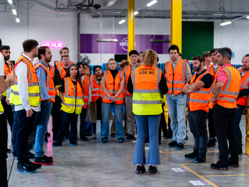 A group of people in safety vests. 