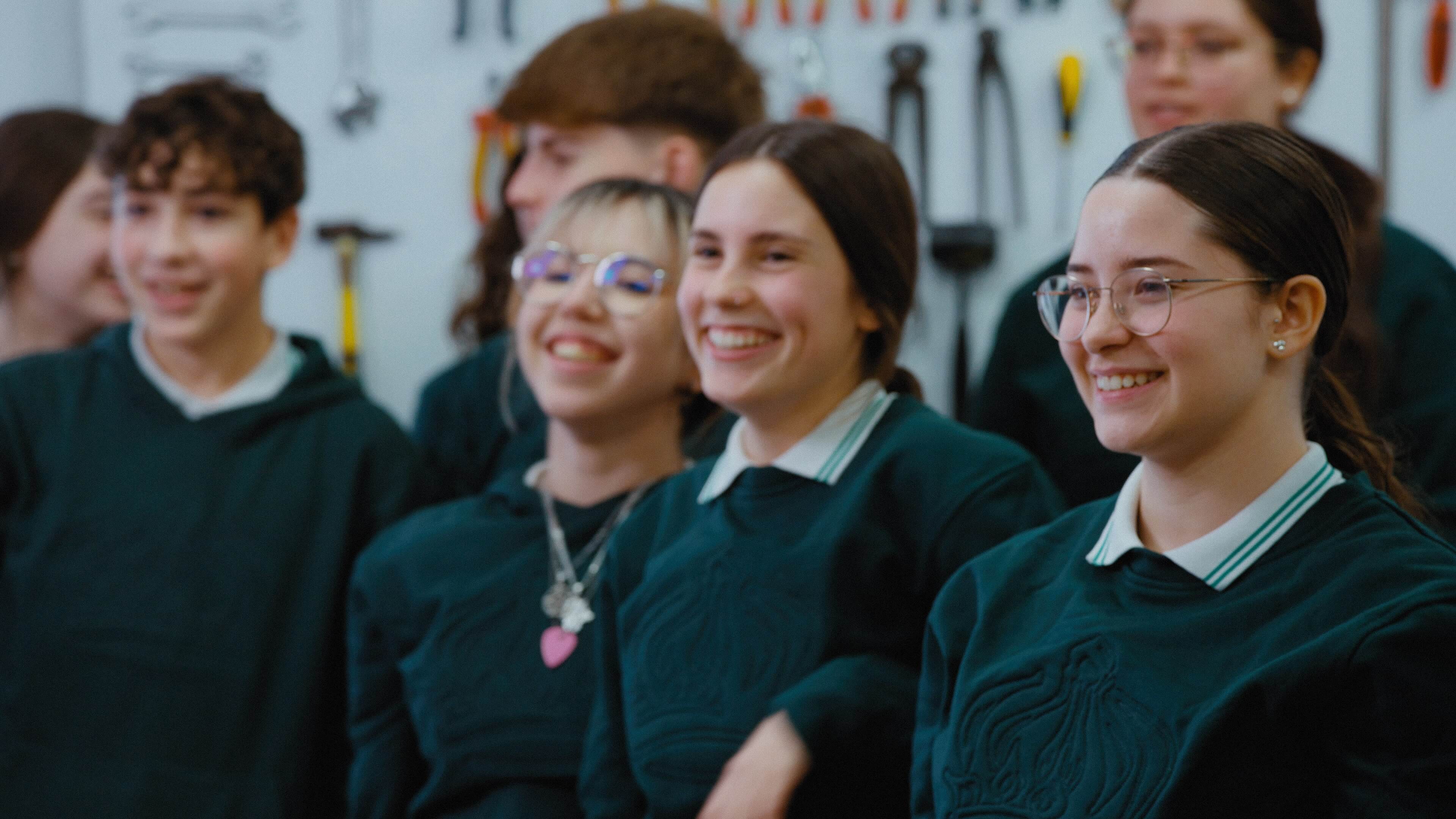 A group of students stand together smiling.