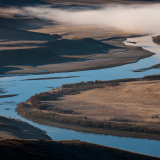 An aerial view of a dry urban landscape at sunset. 