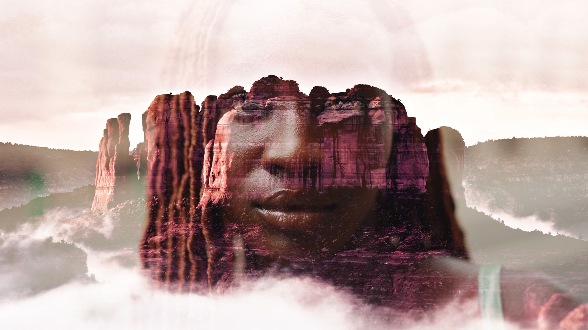A person's face fading into a rocky background.