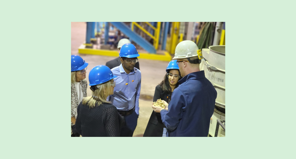 On a site visit to GranBio's Thomaston, Georgia, facility, Amazon team members observe the wood waste feedstock used to produce lower-carbon fuel.