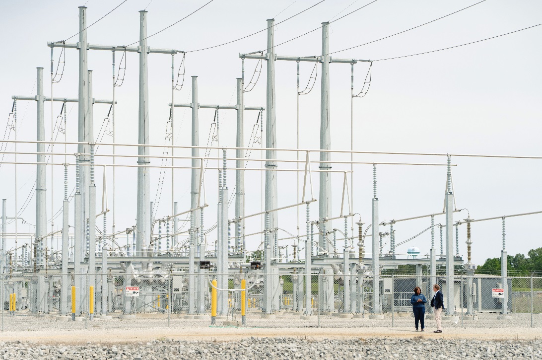 Haley Fisackerly and Kamisha Quaits, vice president of reliability at Entergy Mississippi, meet near an electrical substation in Mississippi.
