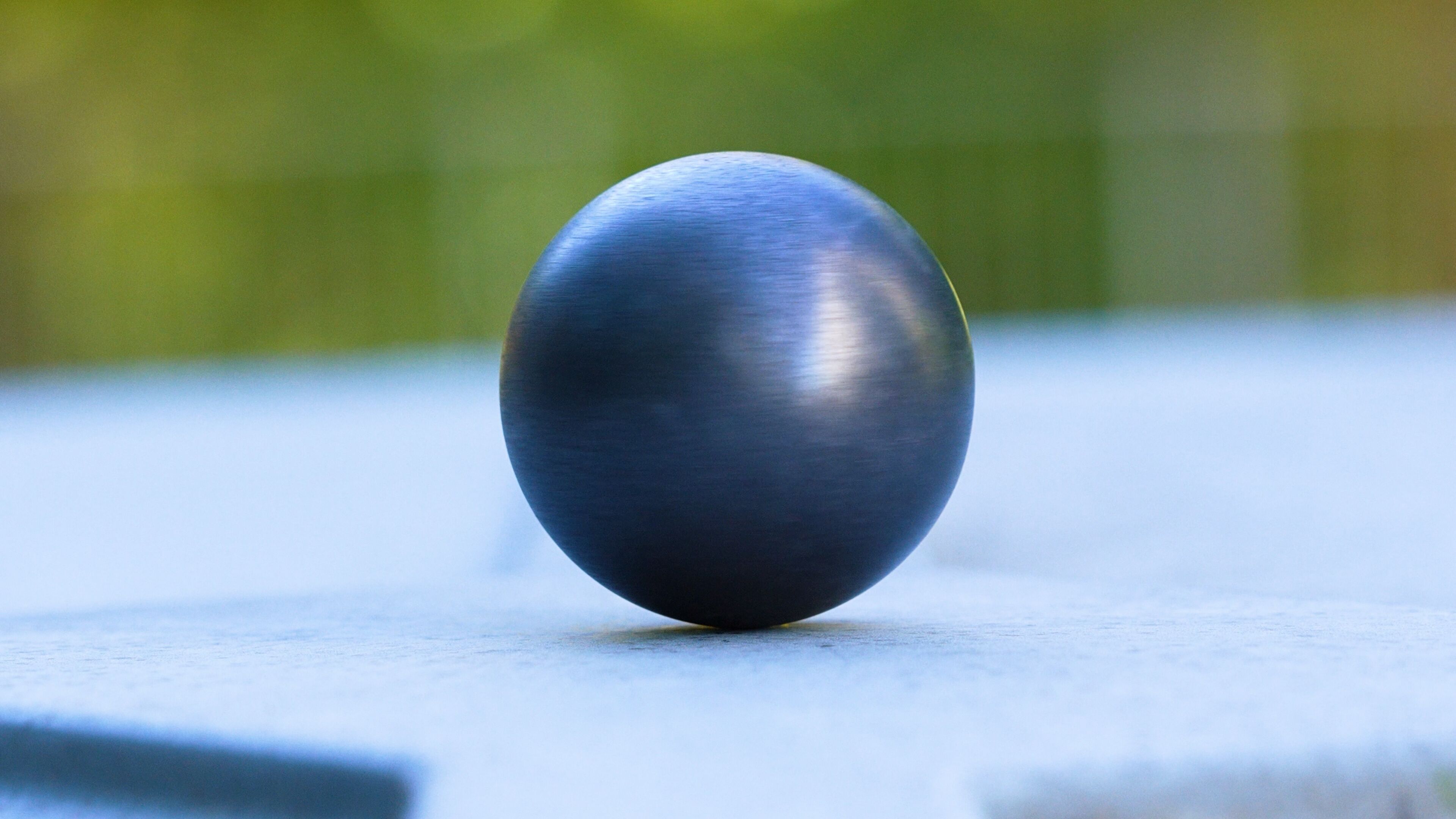 A round object sits on a flat surface. 