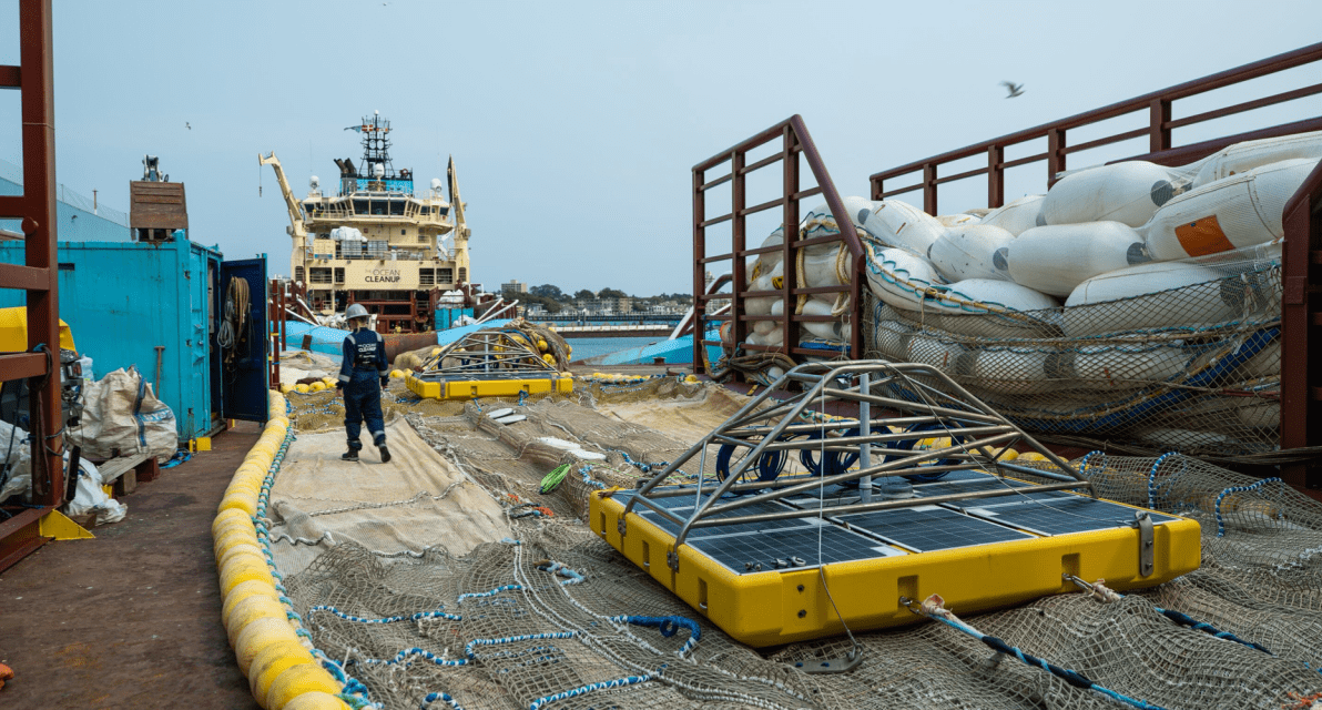 A person walks across the deck of a ship. 