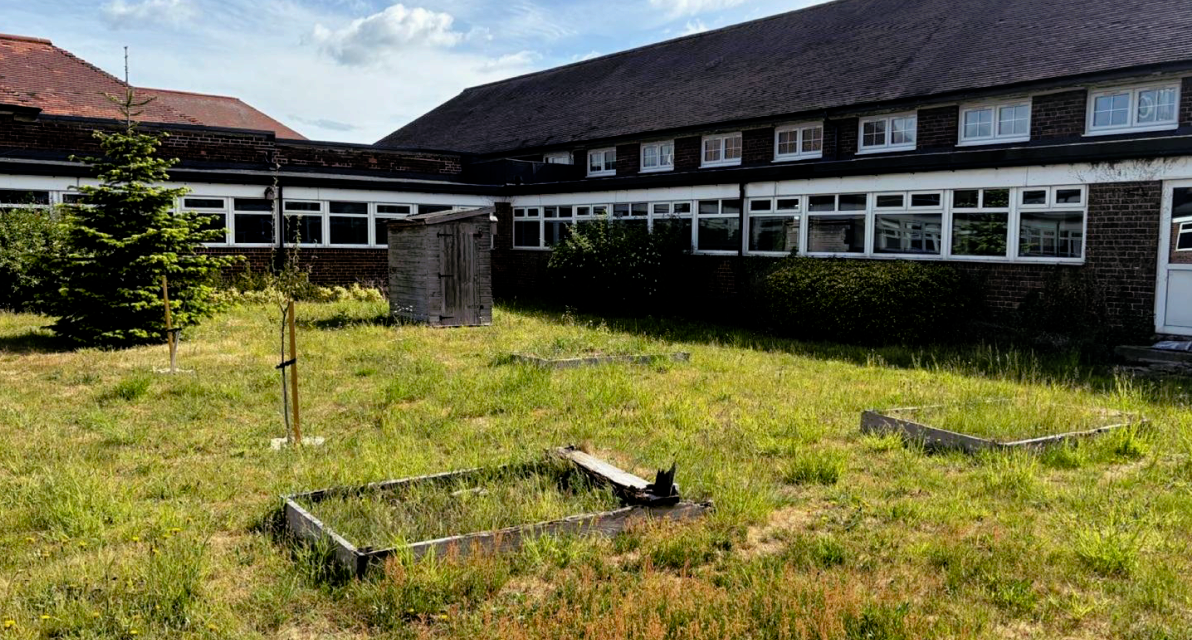 A grass field in front of a building. 