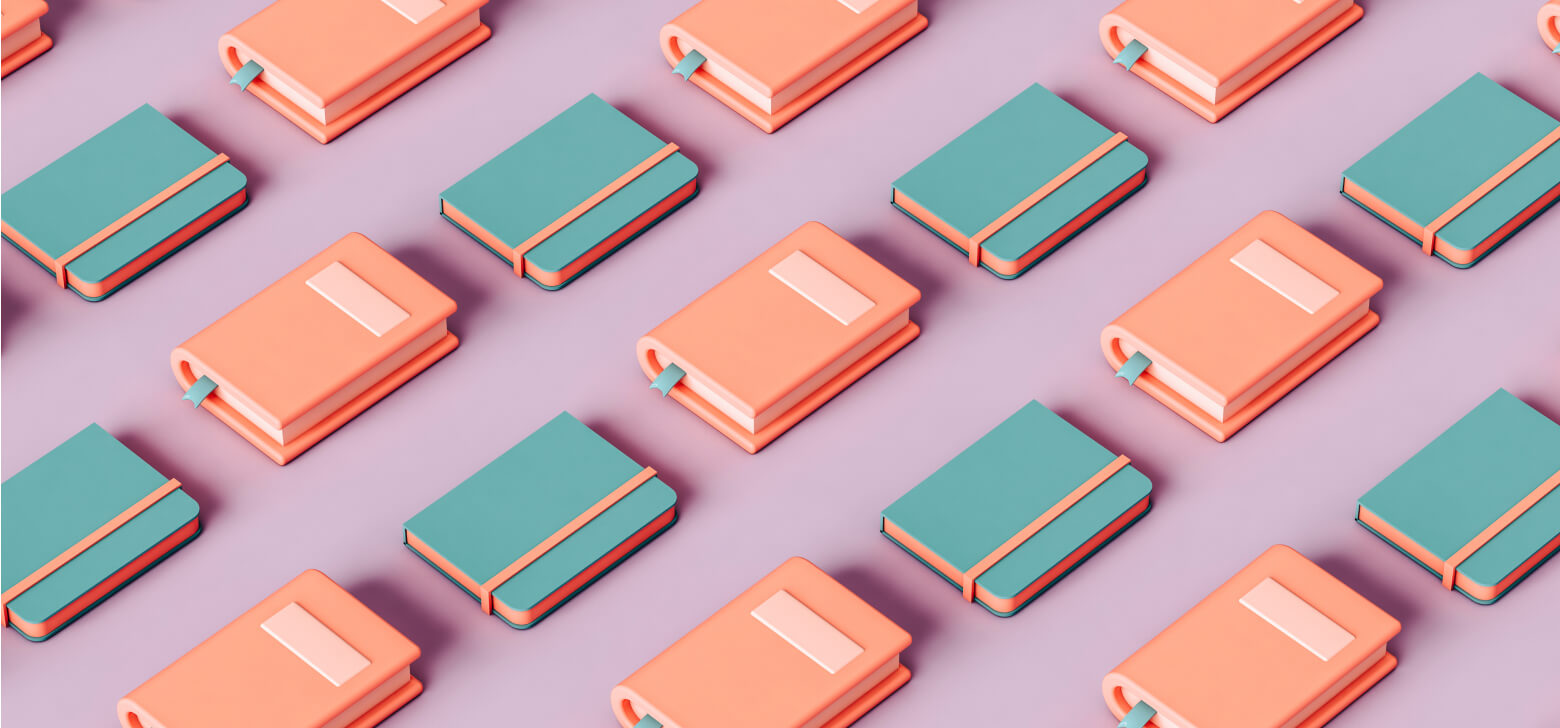 Small blue and orange books laid neatly in rows. 