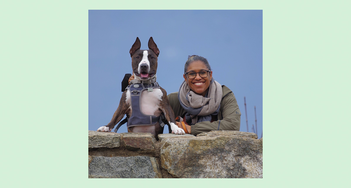 A person smiling next to a dog. 
