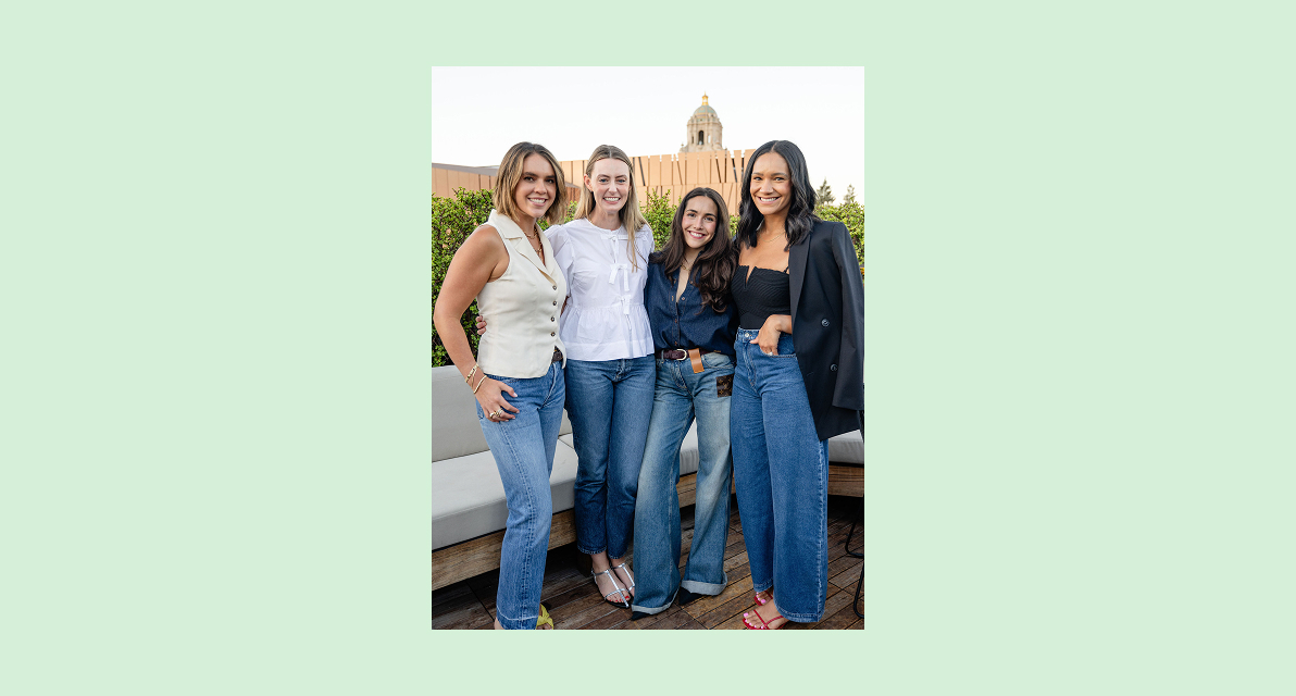 Three people stand smiling for the camera. 