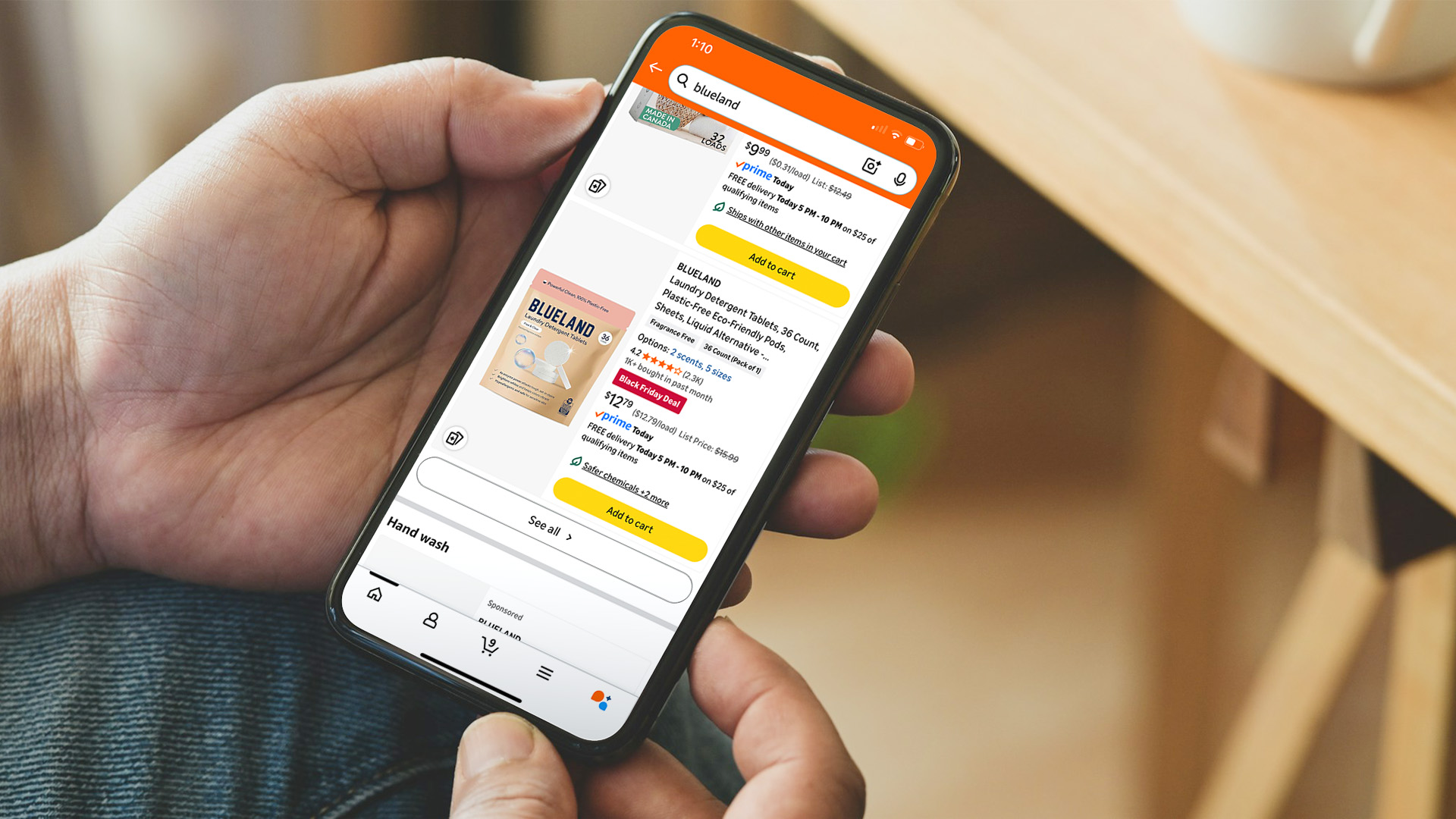 A person scrolls on a phone while shopping online.